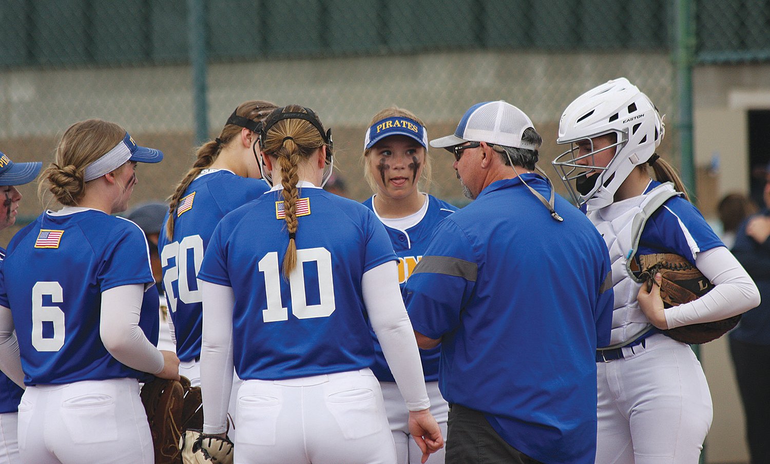 Adna infielders meet with assistant coach Mike McDonald during a win over Forks on Friday during the 2B state softball tournament in Yakima.
